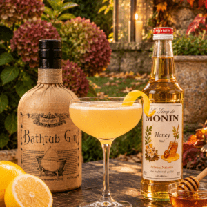 Bee’s Knees Cocktail with Bathtub Gin, Monin Honey Syrup and fresh lemon in an autumn garden